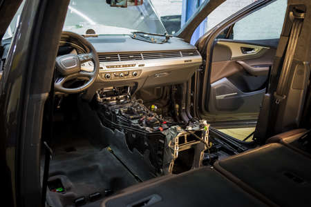 Car repair service center. Dismantled car interior. Check car wiring. Removed chairs, floor trim. leather interior premium crossover. Gearbox repairの写真素材