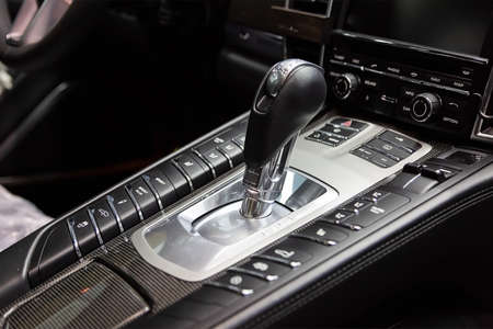 Carbon panel around the gearbox. Aluminum button panel with chrome. Interior luxury sports carの写真素材