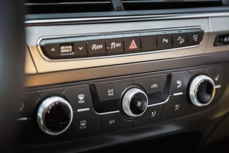 Air ducts and climate control panel in a luxury car with leather top panel.の写真素材