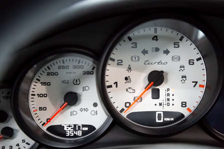 Moscow. November 2018. On-board computer and white dashboard Porsche Panamera Turbo. Tachometer, speedometer, oil level. Red arrows on the dashboard. Luxury German Sedanのeditorial素材