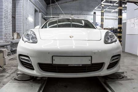 Moscow. November 2018. White Porsche Panamera at the wheel alignment stand of the service center. Sports Porsche, executive class sedan in the tuning and repair center.のeditorial素材
