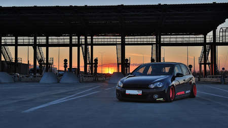 Saint Petersburg. Winter 2018. Black volkswagen golf tuned with pink rims on the road between cities. Against the background of the checkpoint, sunset and traffic jams.のeditorial素材