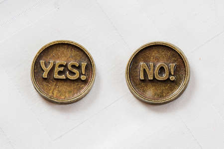 Bronze metal coins Yes or No. Coin for make choice. On white background. Decision makingの写真素材
