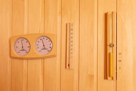 Sauna thermometer and hygrometer, Hourglass on wooden wall. Accessoriesの写真素材