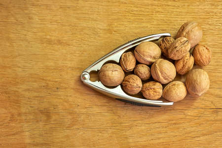 Arrow from walnuts and nutcracker on a wooden background.の写真素材