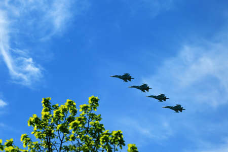 Combat aircraft fighters fly against the blue sky. Jet squadronの写真素材