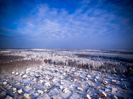 Village in forest. Winter aerial viewの写真素材