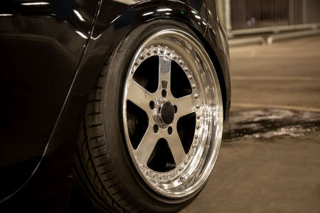 Alloy polished rims of a sports car. Wide wheels with stretched tires. Tuned low carの写真素材