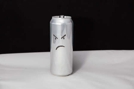 The concept of grumpy man. Angry emoticon on aluminium can, Emoji with rageful faceの写真素材