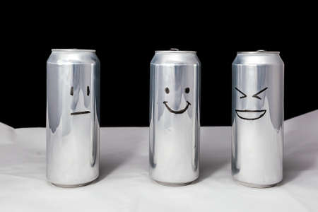 Concept of ridicule. Joke over a friend but it's not funny to him. Aluminium cans with drowing...