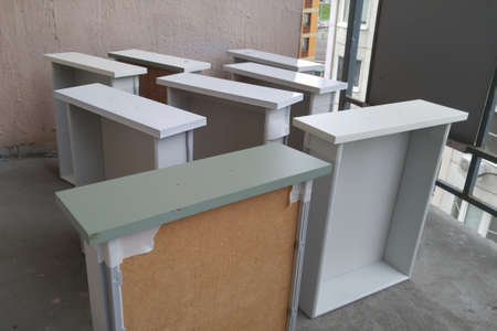 Painting the drawers of the cabinet and the bedside tables from the paint can. In white color. On the balcony.の写真素材