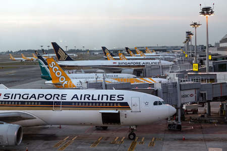 Singapore. March 2019. Changi International Airport. Terminal 2. Plane fleet at the airport. Planes are preparing for departure.のeditorial素材