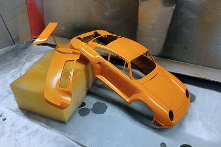 Scale model hobby. Paint the spoiler, trunk lid and toy body in a bright orange color.の写真素材