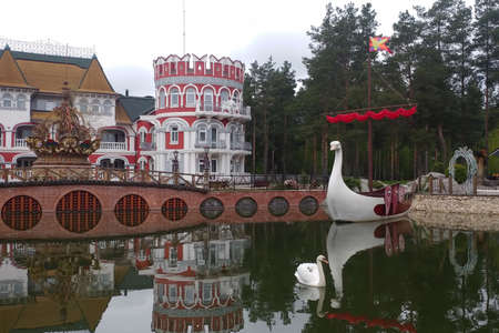 Ryazan, Russia - April 14, 2019: Bridge and lake of Ethnic hotel "ÐÐ°Ðº v staroy skazke" in Russian style. Hotel "Like an old fairy tale." Made in the ethnic Russian style and located in the forest.のeditorial素材