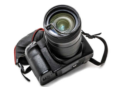 Broken digital SLR camera, dented protective filter on the zoom lens. Will be repaired. Isolated on...