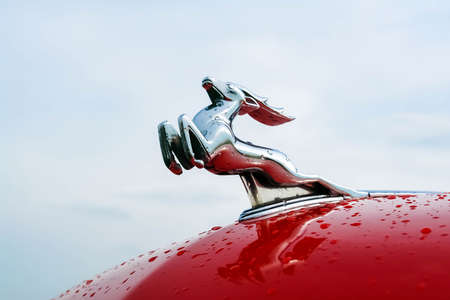 Moscow, Russia - May 25, 2019: A deer on the red hood of a Gaz-21 Volga car against the sky. Russian...