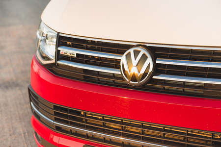St. Petersburg, Russia - July 22, 2019: Red and white colored modern Volkswagen Multivan California...