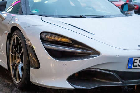 Moscow, Russia - October 9, 2019: White McLaren 720S in the parking lot. Under rain. Closeup of...