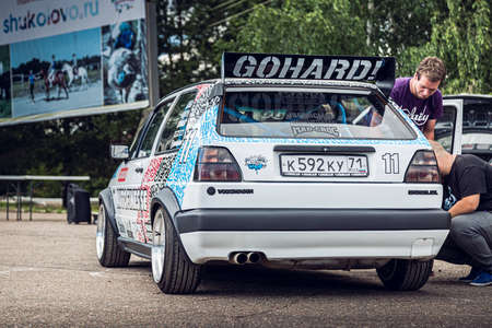 Moscow, Russia - July 06, 2019: White Volkswagen Golf 2 powerfully tuned for racing with a roll cage, an aerodynamic spoiler, an understated car with custom BBS wheels. Rally