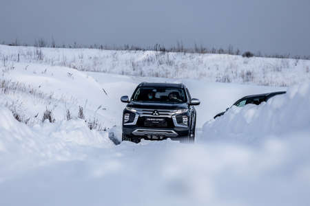 Moscow, Russia - February 17, 2021: All new Mitsubishi Pajero Sport. Facelifted suv. winter, the car is driving off-road. the front of the updated SUV.のeditorial素材