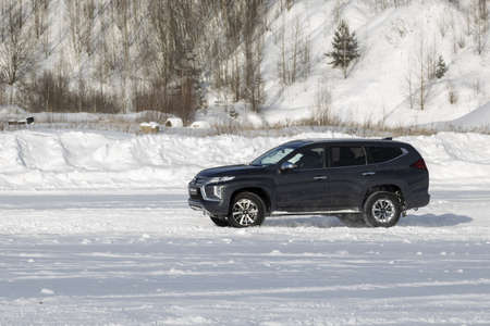 Moscow, Russia - February 17, 2021: All new Mitsubishi Pajero Sport. Facelifted suv. winter, the car is tested at the test site the front of the updated SUV. Front and half viewのeditorial素材