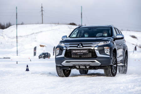 Moscow, Russia - February 17, 2021: All new Mitsubishi Pajero Sport. Facelifted suv. winter, the car is tested at the test site the front of the updated SUV. Front and half viewのeditorial素材