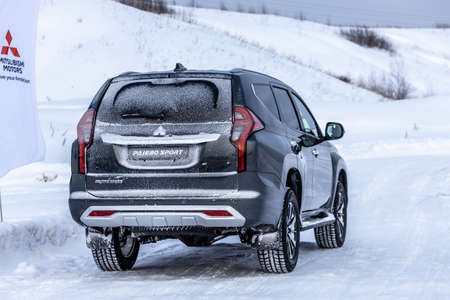 Moscow, Russia - February 17, 2021: All new Mitsubishi Pajero Sport. Facelifted suv. Side and backside view. winter, the car is driving off-road.のeditorial素材