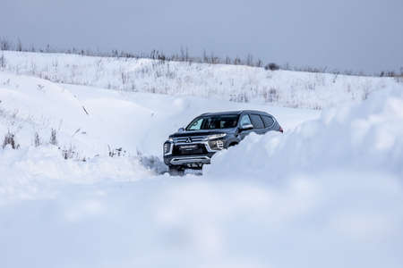Moscow, Russia - February 17, 2021: All new Mitsubishi Pajero Sport. Facelifted suv. winter, the car is driving off-road. the front of the updated SUV.のeditorial素材