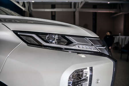 Moscow, Russia - February 17, 2021: All new Mitsubishi Pajero Sport. Details. Closeup of LED headlights, bumper, hood, radiator grill, taillights, side fenders, mirrors.のeditorial素材
