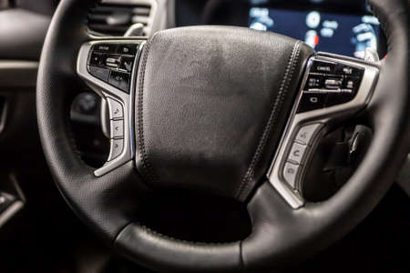Multifunctional leather steering wheel in black in a modern car.の写真素材