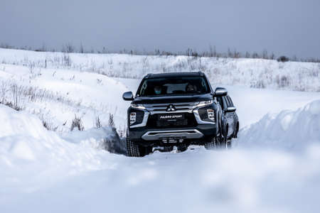 Moscow, Russia - February 17, 2021: All new Mitsubishi Pajero Sport. Montero. Car stand at the parking box, dark light.のeditorial素材