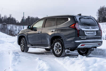 Moscow, Russia - February 17, 2021: All new Mitsubishi Pajero Sport. Facelifted suv. Side and backside view. winter, the car is driving off-road.のeditorial素材