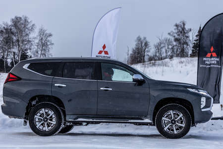 Moscow, Russia - February 17, 2021: All new Mitsubishi Pajero Sport. Facelifted suv. Side and backside view. winter, the car is driving off-road.のeditorial素材