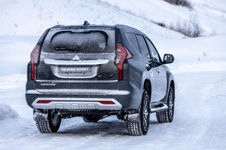 Moscow, Russia - February 17, 2021: All new Mitsubishi Pajero Sport. Facelifted suv. Side and backside view. winter, the car is driving off-road.のeditorial素材