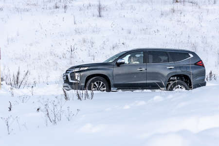 Moscow, Russia - February 17, 2021: All new Mitsubishi Pajero Sport. Facelifted suv. Side and backside view. winter, the car is driving off-road.のeditorial素材