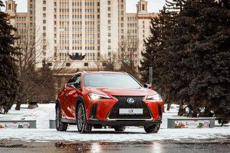 Russia, Moscow - February 05, 2020: Red premium crossover hatchback Lexus UX on the city streets. Hybrid car in winter.のeditorial素材