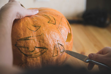 preparation for the holiday. The process of carving a Halloween pumpkin on the table.の写真素材