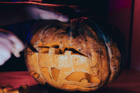 preparation for the holiday. The process of carving a Halloween pumpkinの写真素材