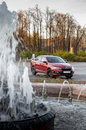 MOSCOW, RUSSIA - OCTOBER 10, 2022: Red Skoda Rapid 22 parked on the street front view verticalのeditorial素材