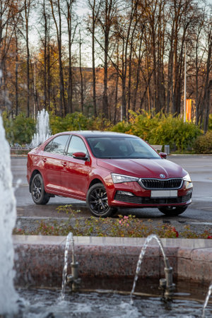 MOSCOW, RUSSIA - OCTOBER 10, 2022: Red Skoda Rapid 22 parked on the street front view verticalのeditorial素材