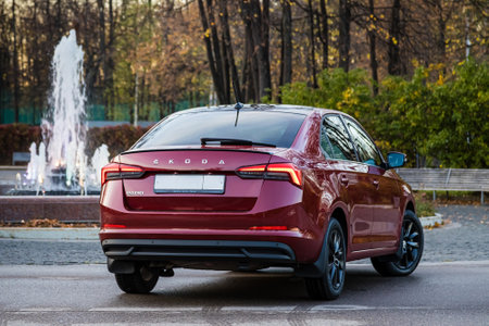 MOSCOW, RUSSIA - OCTOBER 10, 2022: Reg Skoda Rapid 22 parked on the street near the fountain back side viewのeditorial素材
