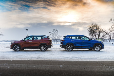 Kostroma, Russia - November 8, 2022: Red and blue Kia Seltos two suv cars parked on the streetのeditorial素材