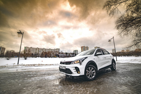 Moscow, Russia - January 29, 2021: The all-new Kia Rio x 2021 hatchback restyled and updated, white. stands on the street opposite the pond winter.のeditorial素材