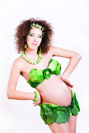 beautiful pregnant young woman dressed in cabbageの写真素材