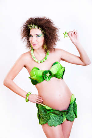 beautiful pregnant young woman dressed in cabbageの写真素材