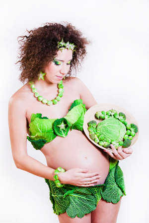beautiful pregnant young woman dressed in cabbageの写真素材