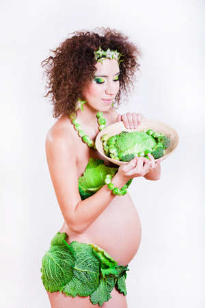 beautiful pregnant young woman dressed in cabbageの写真素材