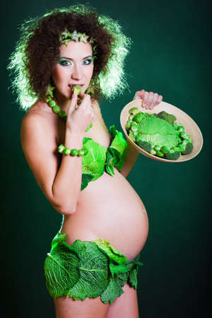 beautiful pregnant young woman dressed in cabbageの写真素材