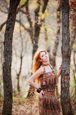 The red-haired girl in autumn leaves 
outdoor shot
の写真素材