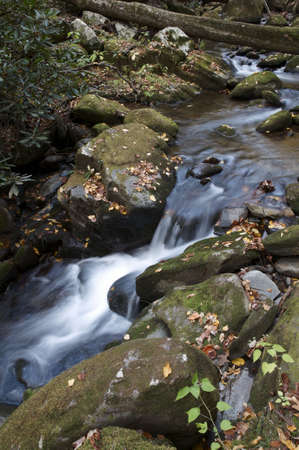 Water flowing over rocks in a mountain stream.の写真素材